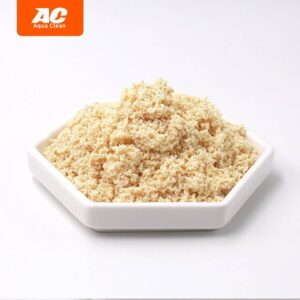 Aqua Clean Nitrate Remover granules in a white dish, showcasing effective algae prevention for aquariums.