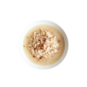 Kit Cat boneless chicken shreds and smoked fish flakes in a bowl, perfect for sensitive stomachs and grain-free diets.