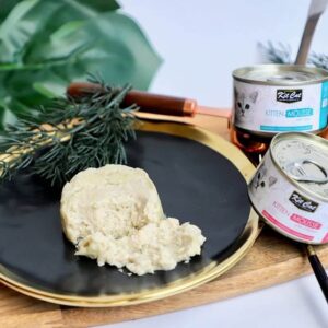 Kit Cat Kitten Tuna Mousse served on a black plate, showcasing grain-free, natural ingredients without added colors or preservatives.