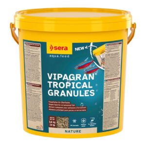 Sera Vipagran granules in yellow bucket, staple food for ornamental fish, supports healthy growth and development.