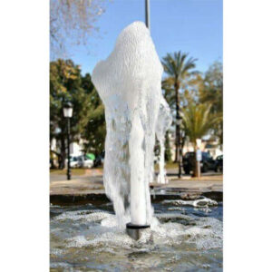 Foam jet fountain nozzle creating a beautiful water feature with a spray effect in a landscaped area.